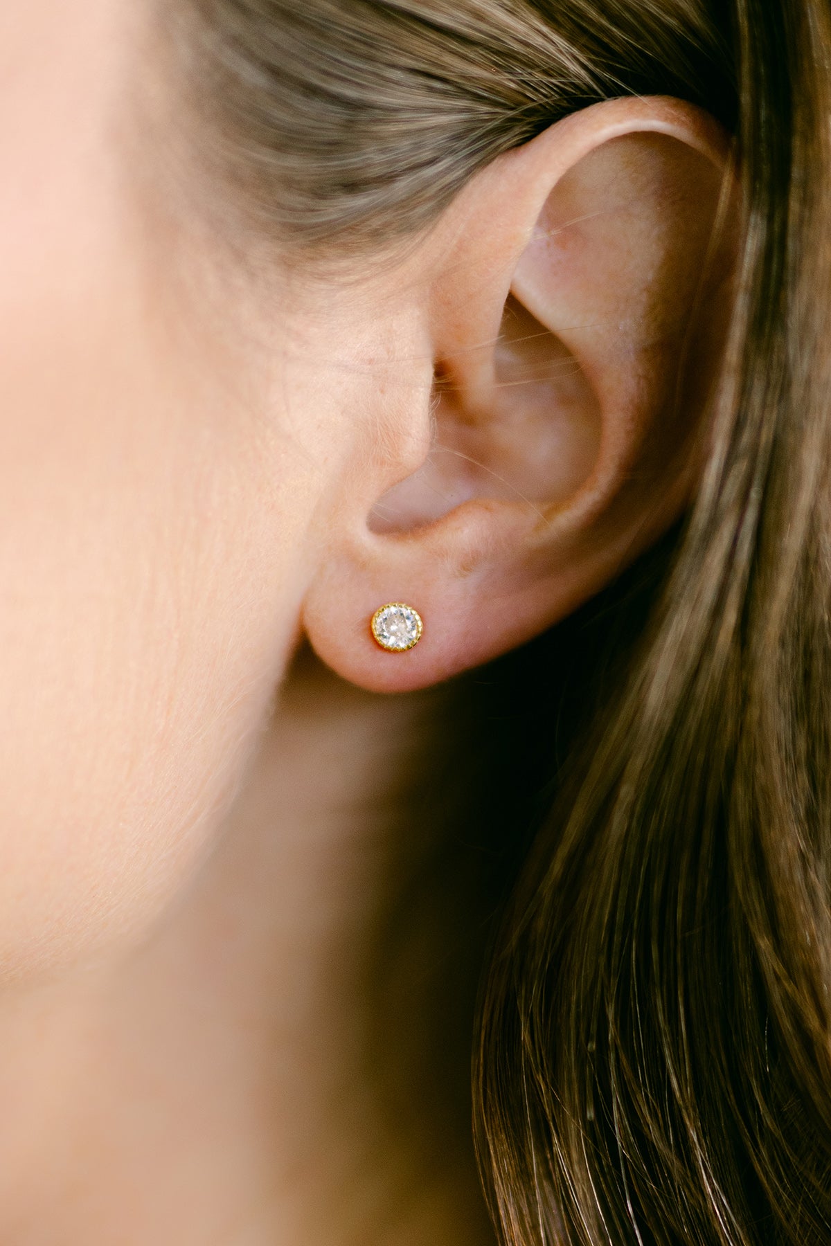 Close-up of an ear wearing a crystal stud earring. Everyday jewelry. Statement Earrings. Small Canadian jewelry brands. 