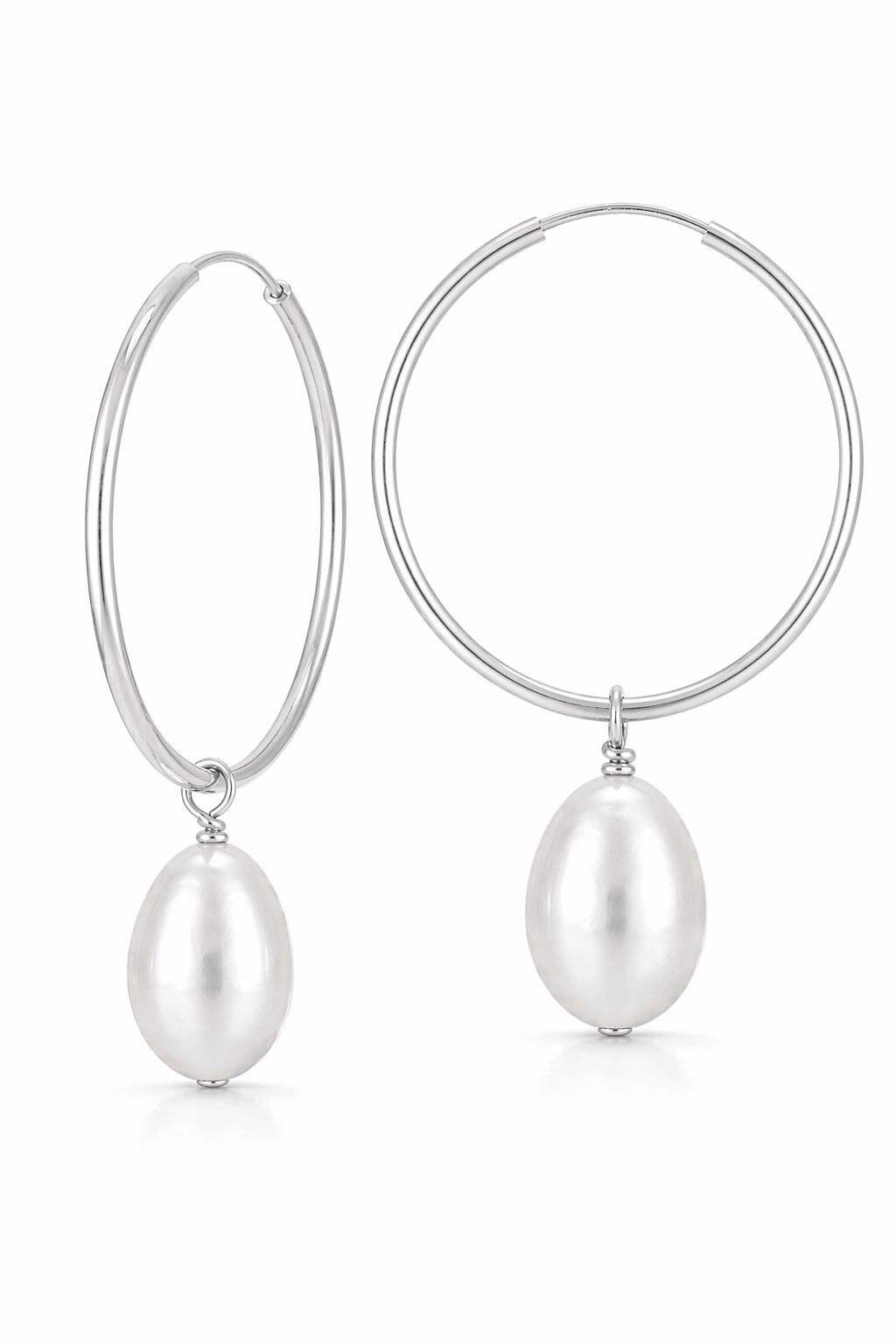 Sterling silver hoop earrings with fresh water pearl drops on a white background. Everyday earrings, minimalist jewelry, & handmade pearl jewelry by BIPOC jewelry designer
