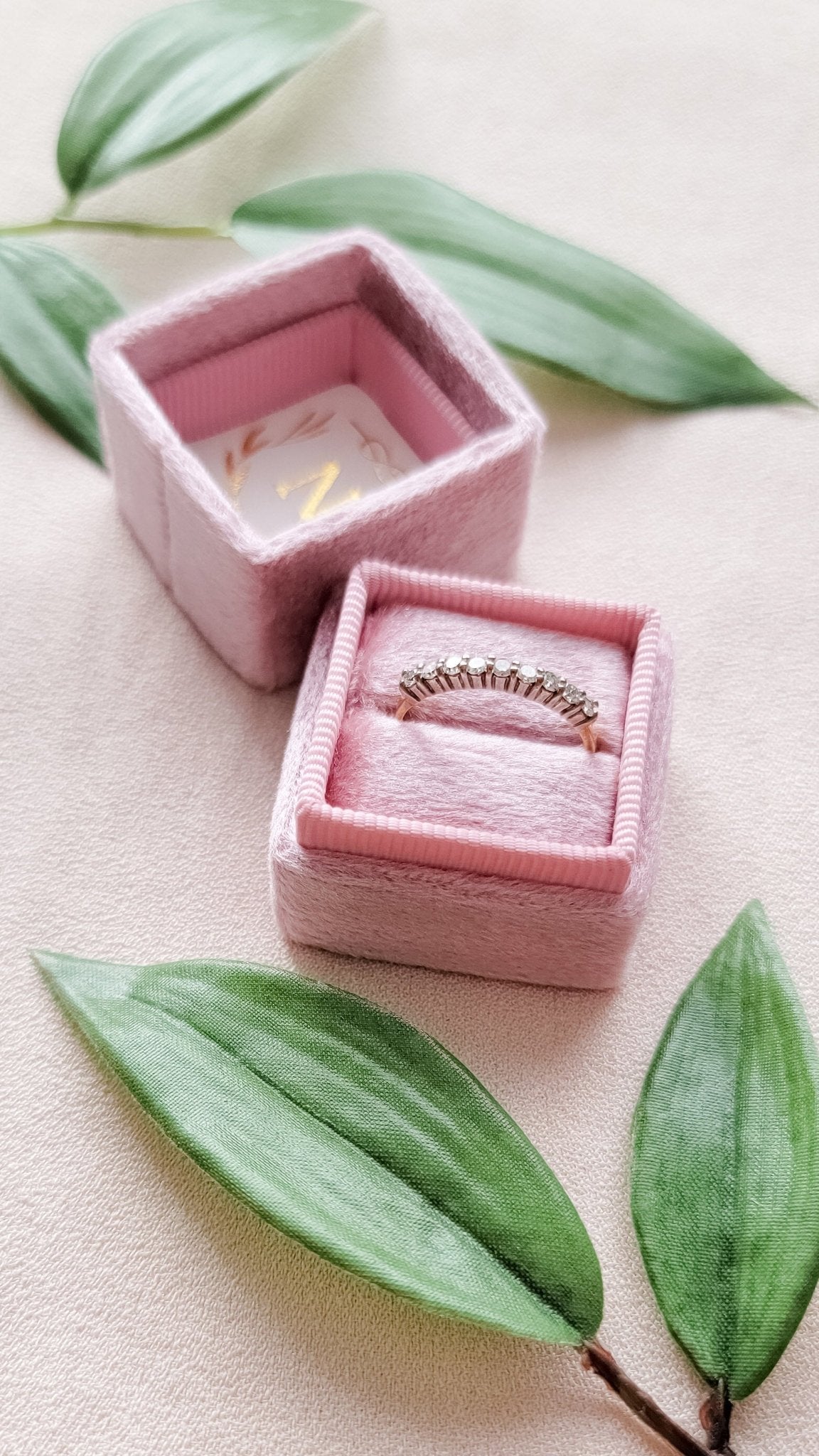 18k Gold Diamond Vintage Engagement Ring in a ring box surrounded by leaves. 