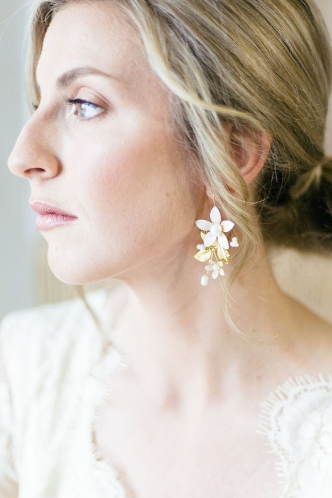 Contemplative bride looks on while her floral earrings make a statement. They are gold-filled and dotted with small freshwater pearls. 