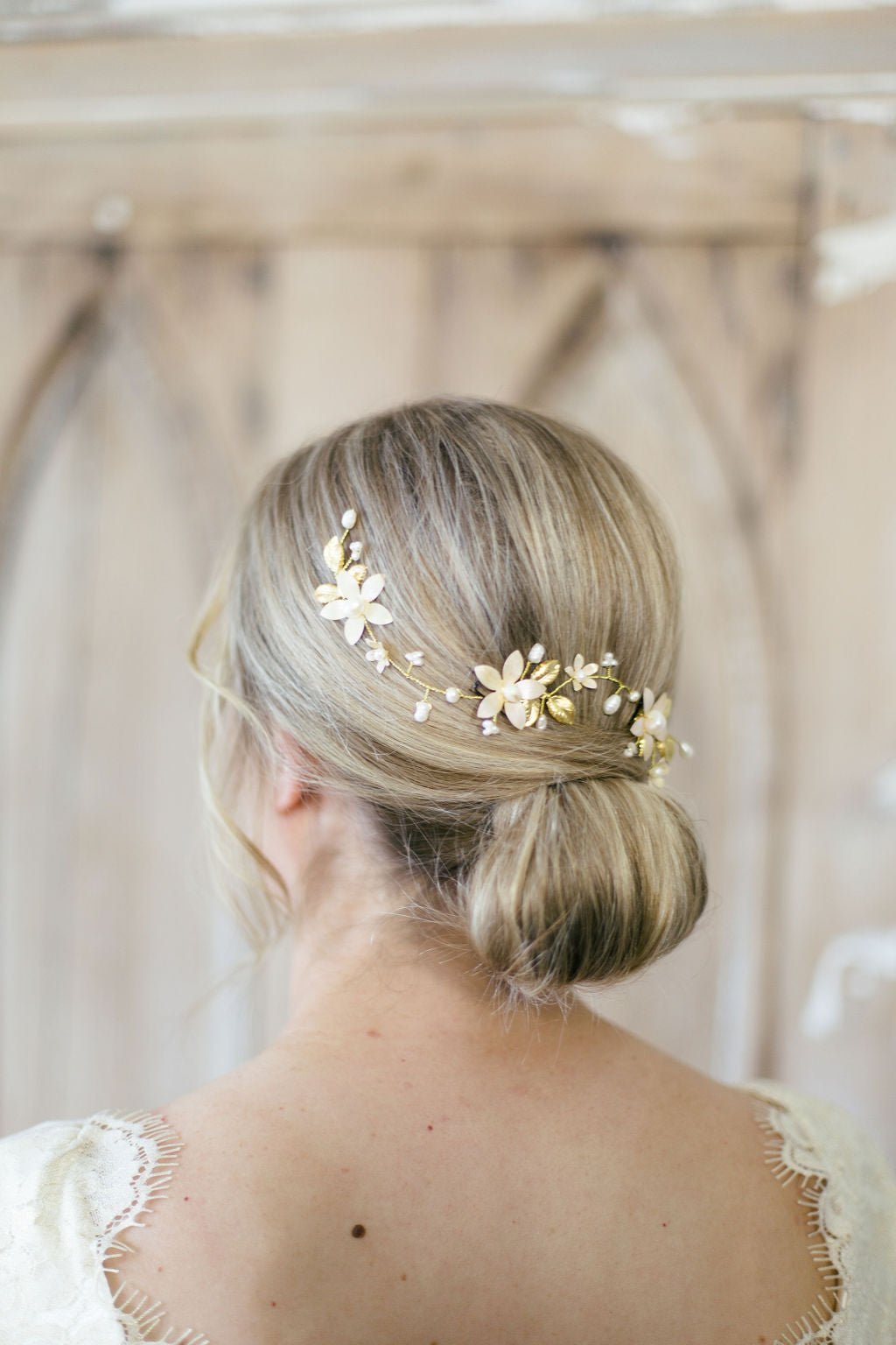 Evanthe Floral Bridal Hairvine with Fresh Water Pearls and Enamel Flowers woven into a bridal hair-do from the back. Bridal Hair Accessories. Bridal Accessories. Canadian Bridal Accessories. Handmade Canadian Accessories. Canadian handmade Accessories. Canadian weddings. Wedding Canada. Organic pearl accessories. Pearl Bridal Hair Accessories. Pearl Bridal Accessories.