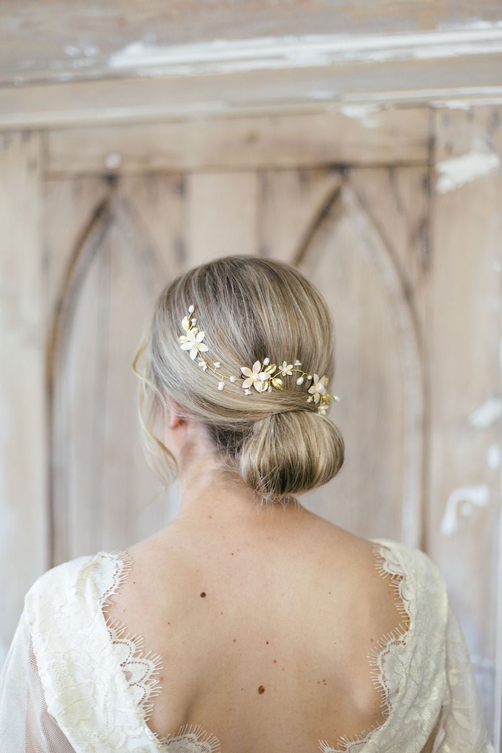 Evanthe Floral Bridal Hairvine with Fresh Water Pearls and Enamel Flowers woven into a bridal hair-do from the back. 