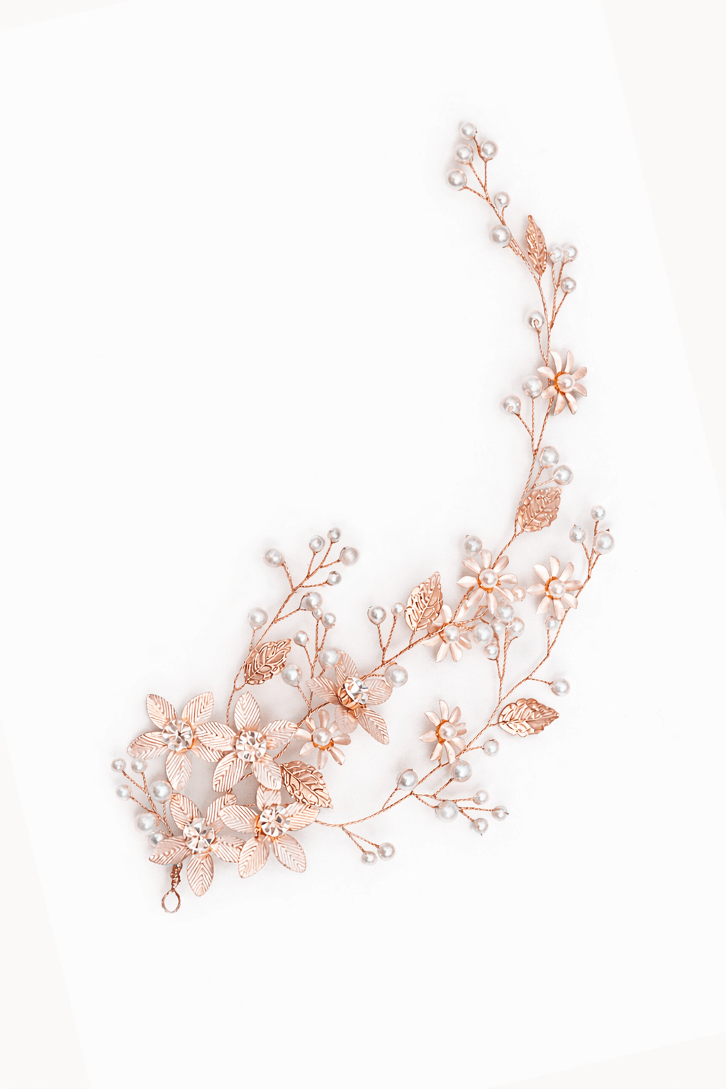 Rose gold floral bridal hair accessory with freshwater pearls & Swarovski crystals on a white background. Handmade bridal accessories & wedding hair accessories by Canadian bridal designer