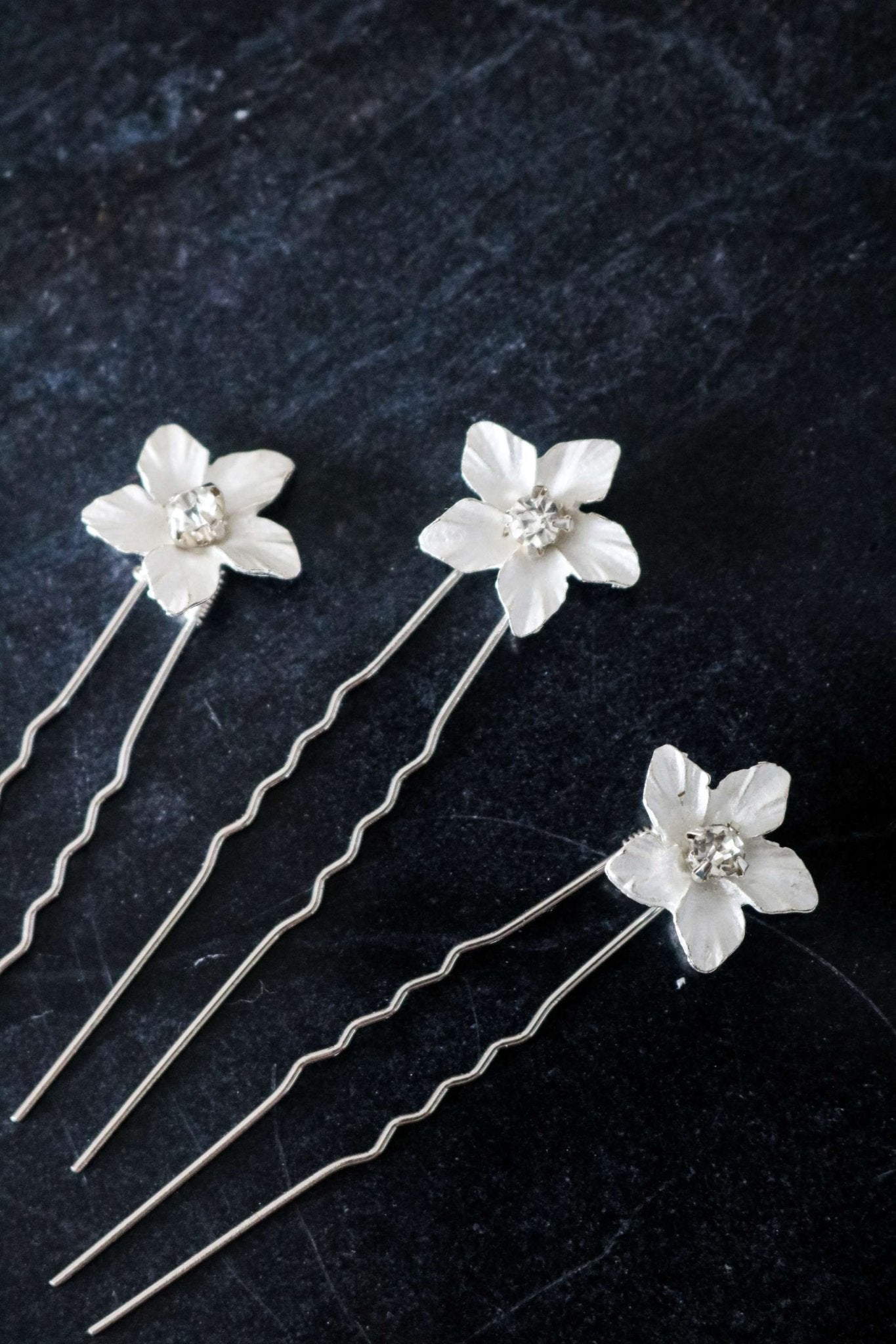 Three Silver Feya Crystal Flower Hairpins on a dark background.