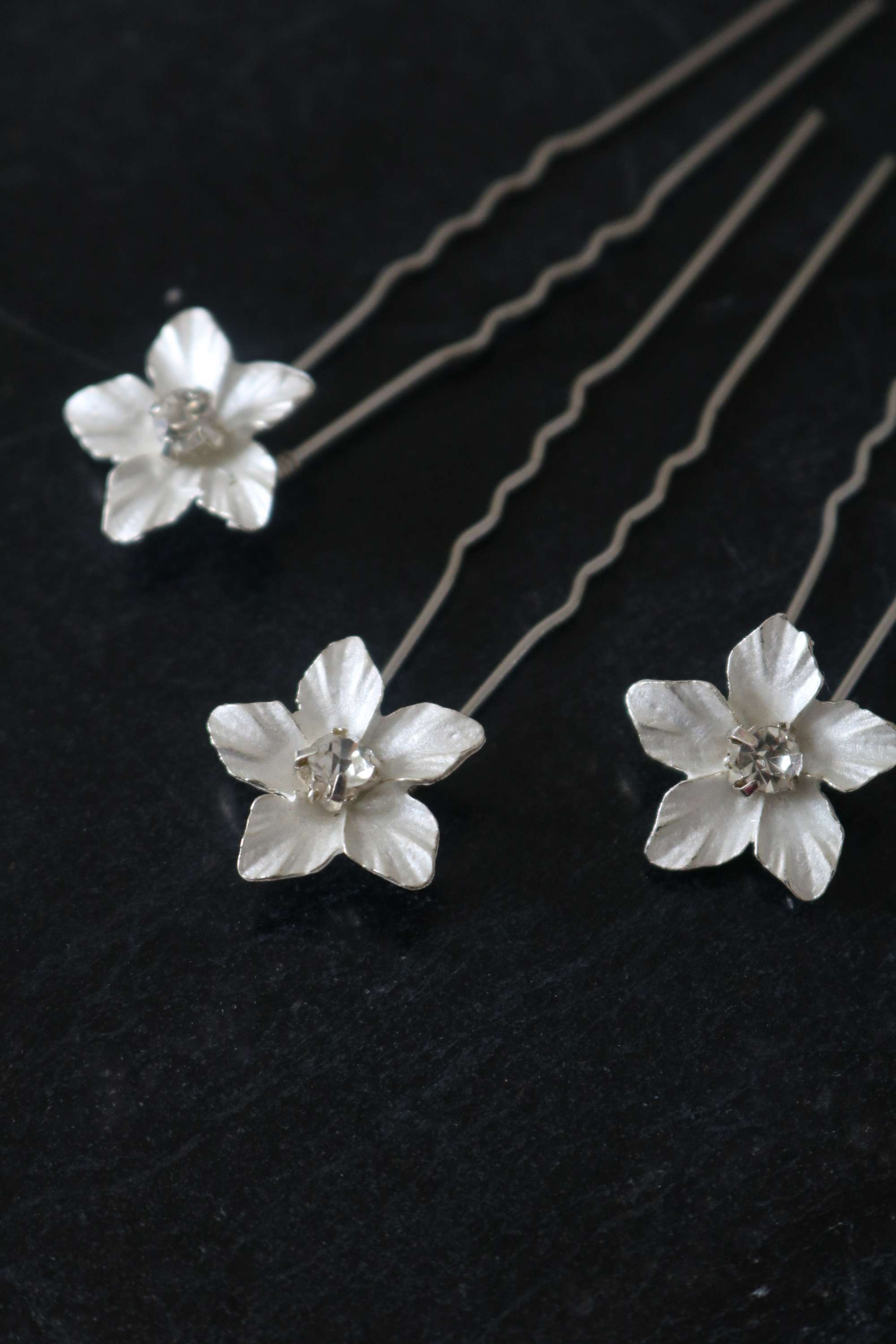 Three Silver Feya Crystal Flower Hairpins on a dark background.