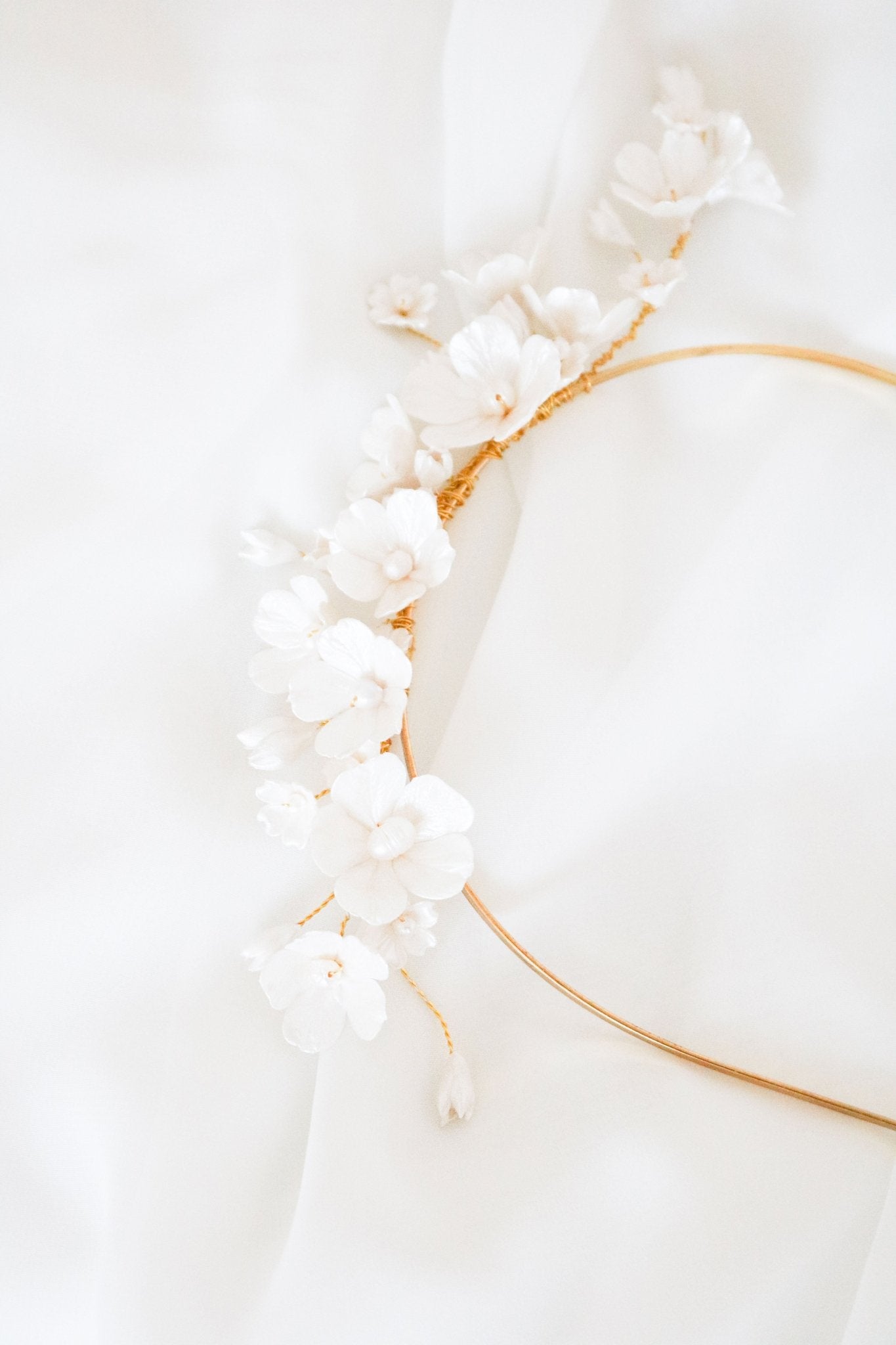 Fleura Fresh Water Pearl and Clay Flower Bridal Headband on a white background. 