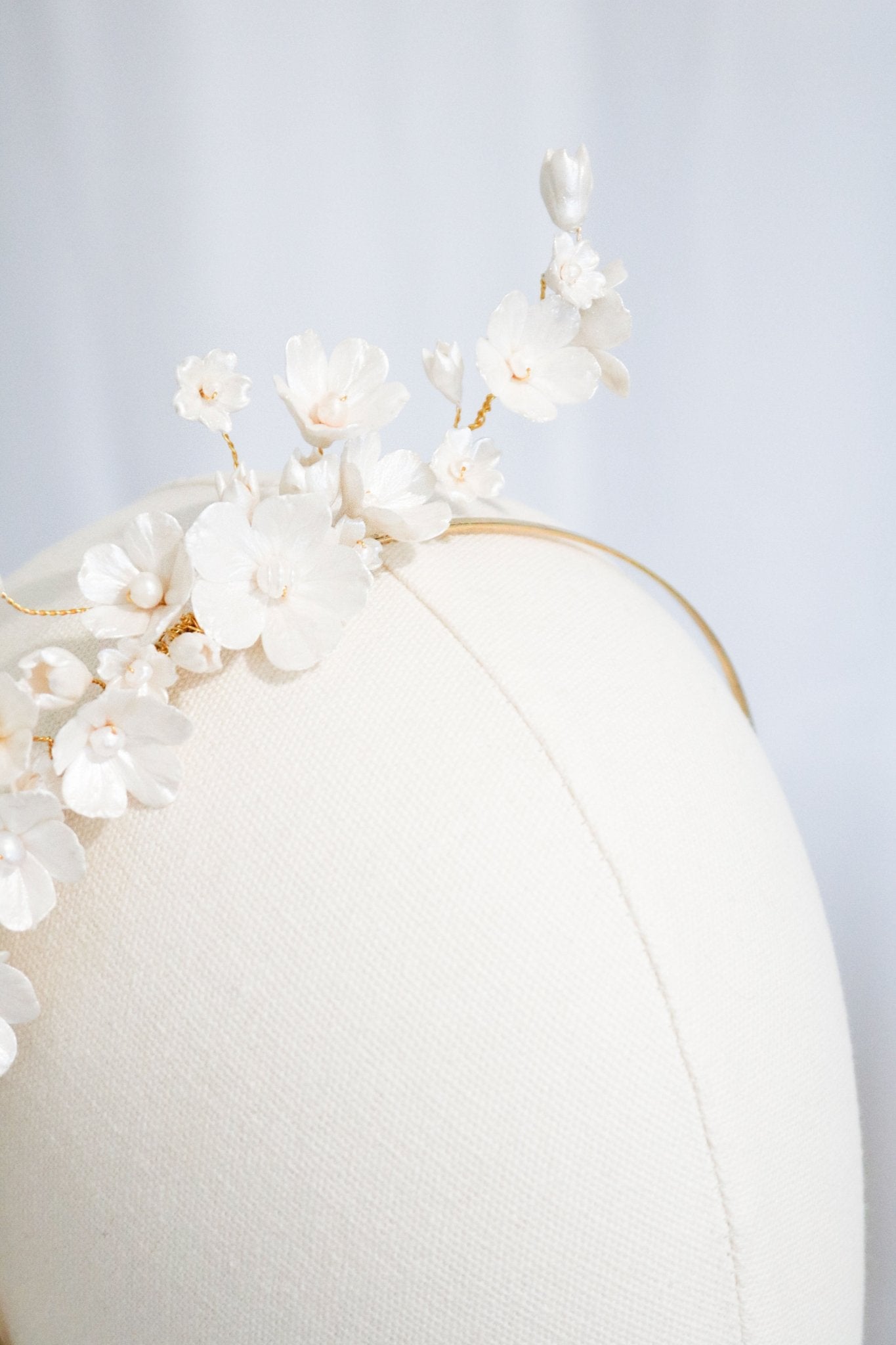 Fleura Fresh Water Pearl and Clay Flower Bridal Headband on a head bust. 