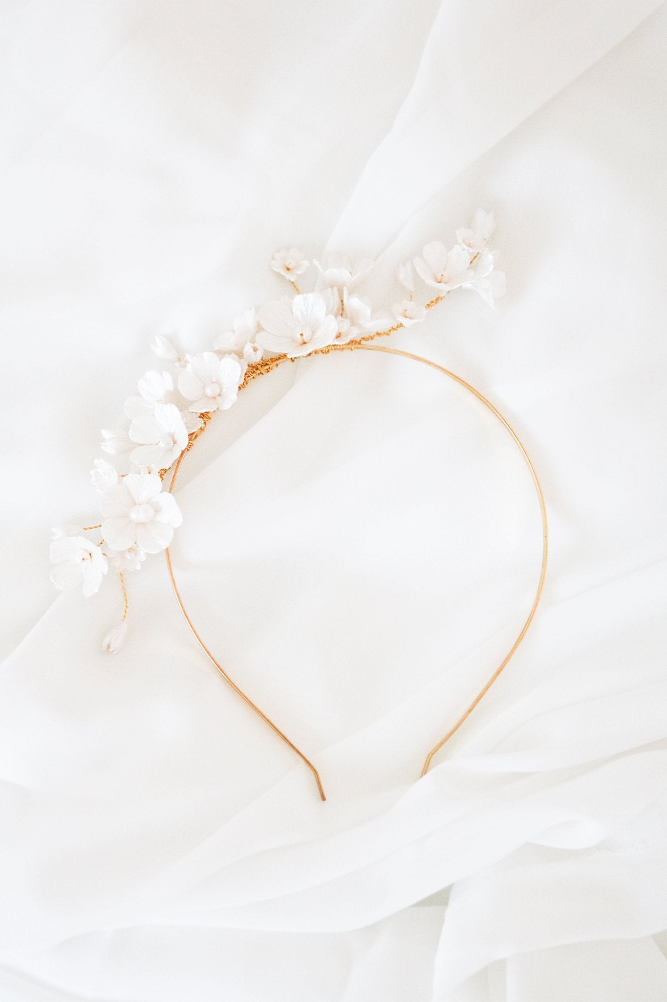 Fleura Fresh Water Pearl and Clay Flower Bridal Headband on a white background. 