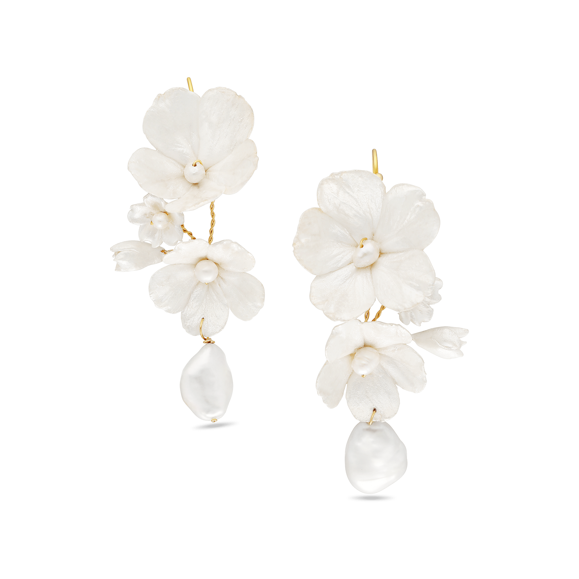 A pair of Gold wire-wrapped freshwater baroque pearls with handmade enamel flowers in white. Statement bridal earrings & pearl bridal jewelry handmade by Canadian jewelry designer