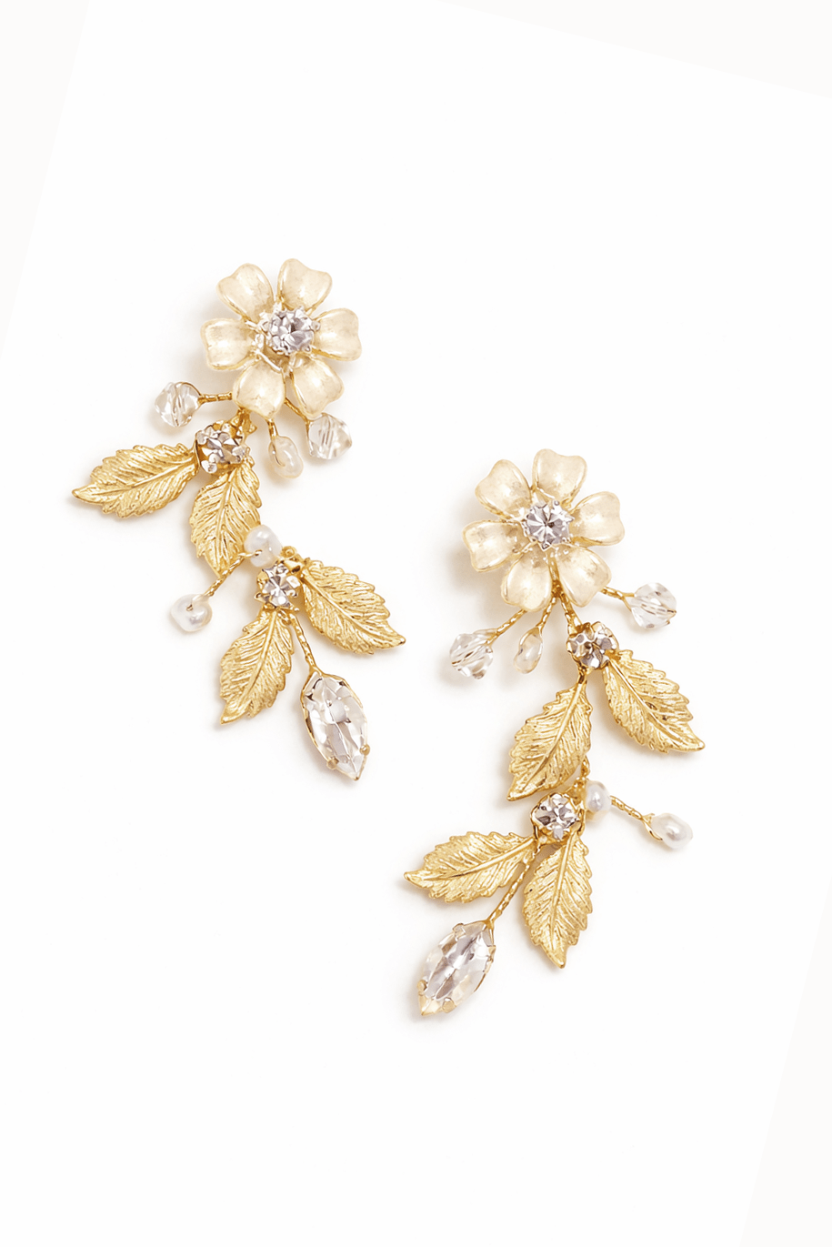 Gold floral leaf bridal earrings with crystals on a white background. Handmade bridal jewelry & statement bridal earrings by woman-owned jewelry business