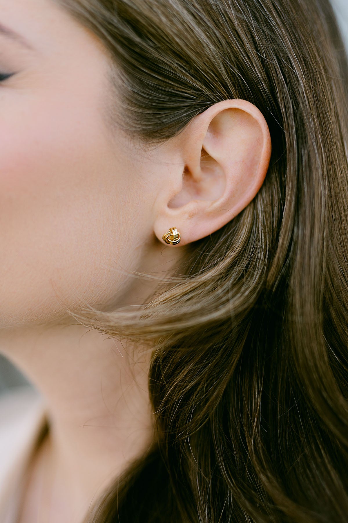 Close-up of an ear wearing a gold-filled stud earring. Small Canadian jewelry brands. Canadian jewelry artisan. Everyday jewelry. 
