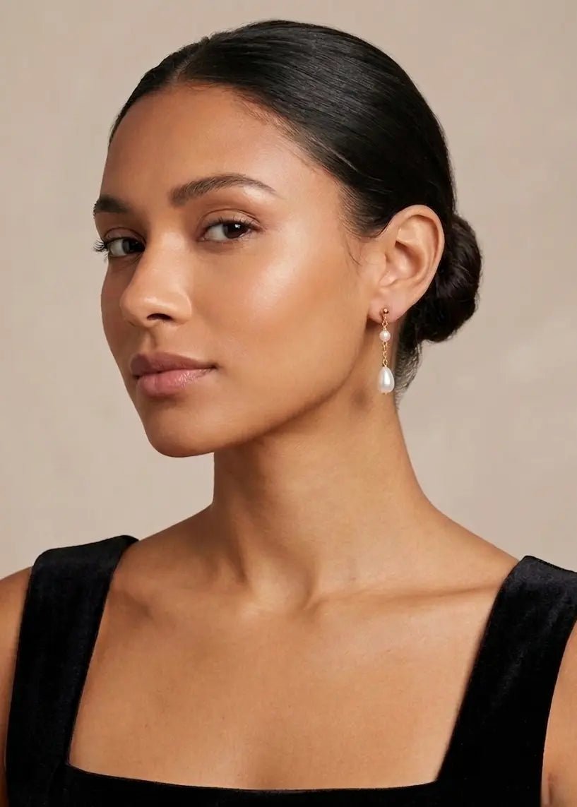 BIPOC woman wearing black top and gold filled fresh water pearl drop earrings. Affordable Canadian jewelry  & Organic pearl jewelry by Small Canadian jewelry brand