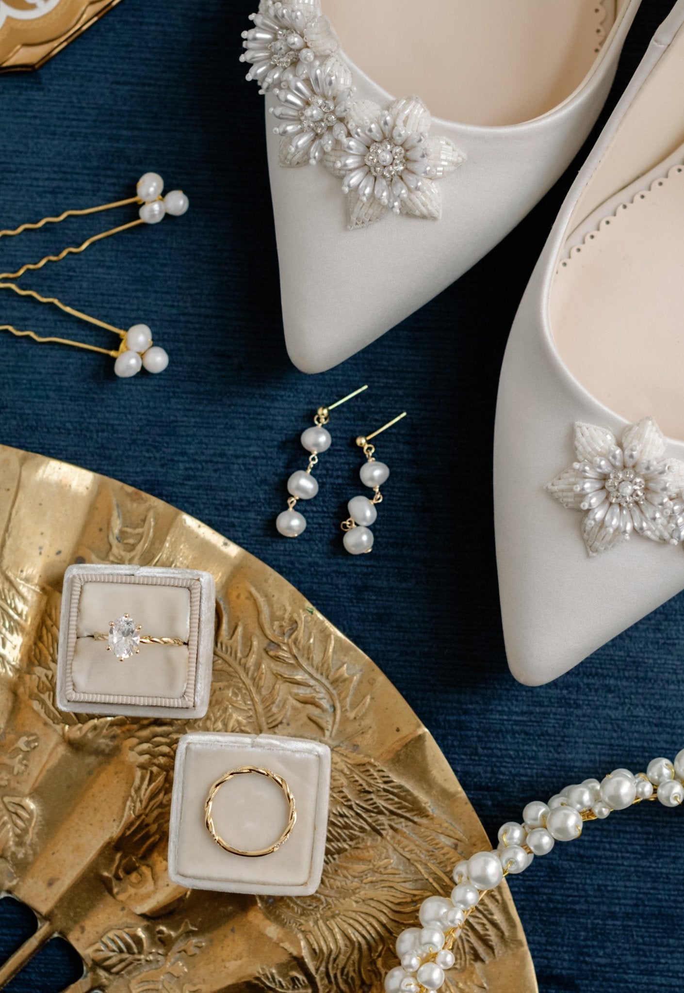 A wedding set consisting of pearl and beaded shoes, two golden pearl hairpins, a pearl clustered headband, two gold rings (one with diamond), and gold-filled drop earrings with 3 freshwater pearls each. 