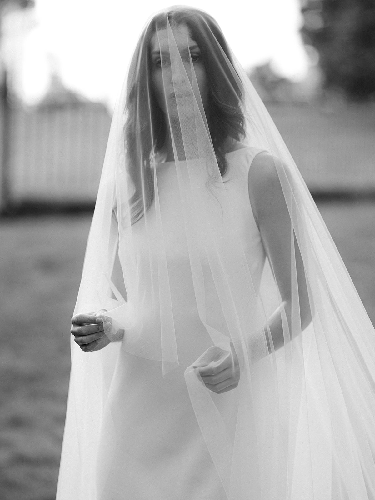 A new bride in her Heavenly Full Wedding Veil with Blusher in black and white photo. 