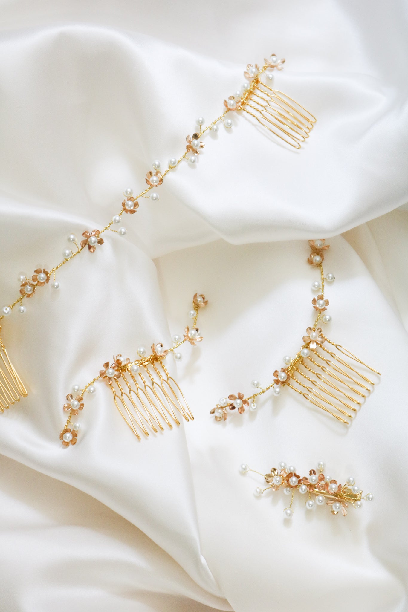 A set of 4 bridal hair accessories including two gold hair combs with freshwater pearls, one gold Swarovski pearl hair barrette, and bridal hairvine. Handmade bridal accessories & bridal hair accessories by BIPOC wedding designer
