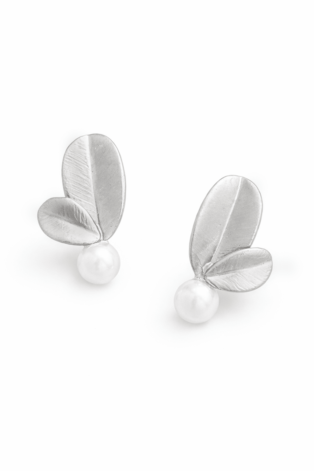 Sterling silver leaf-shaped earrings with natural Philippine pearls on a white background. Handmade pearl earrings & silver bridal earrings by BIPOC jewelry designer