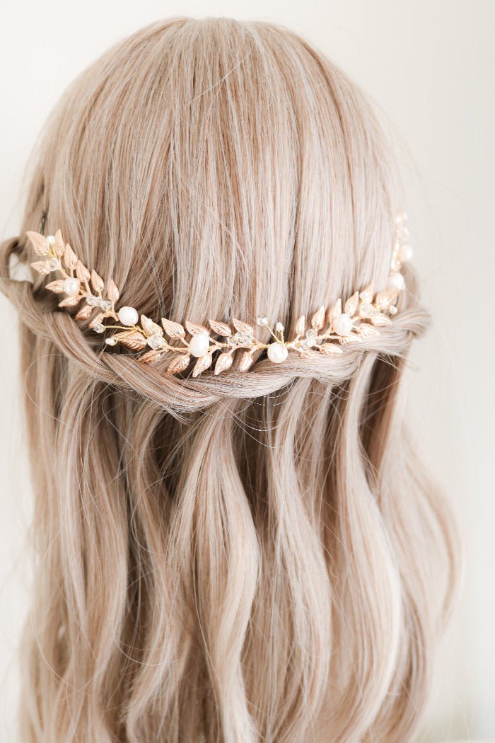 The gold Loriana Laurel Bridal Hairvine with Fresh Water Pearls sitting on the back of a head bust wig over a braid. Organic pearl accessories. Pearl Bridal Hair Accessories. Pearl Bridal Accessories. Bridal Hair Accessories. Bridal Accessories. Canadian Bridal Accessories. Handmade Canadian Accessories. Canadian handmade Accessories. Canadian weddings. Wedding Canada. 