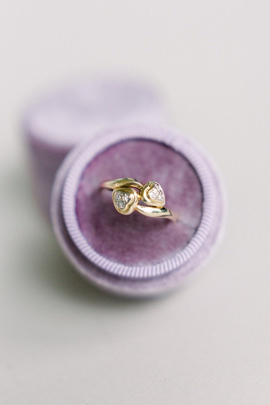 Top view of the Love Bird Vintage Diamond Engagement Ring in 10k Gold and Platinum in a round purple ring box. 