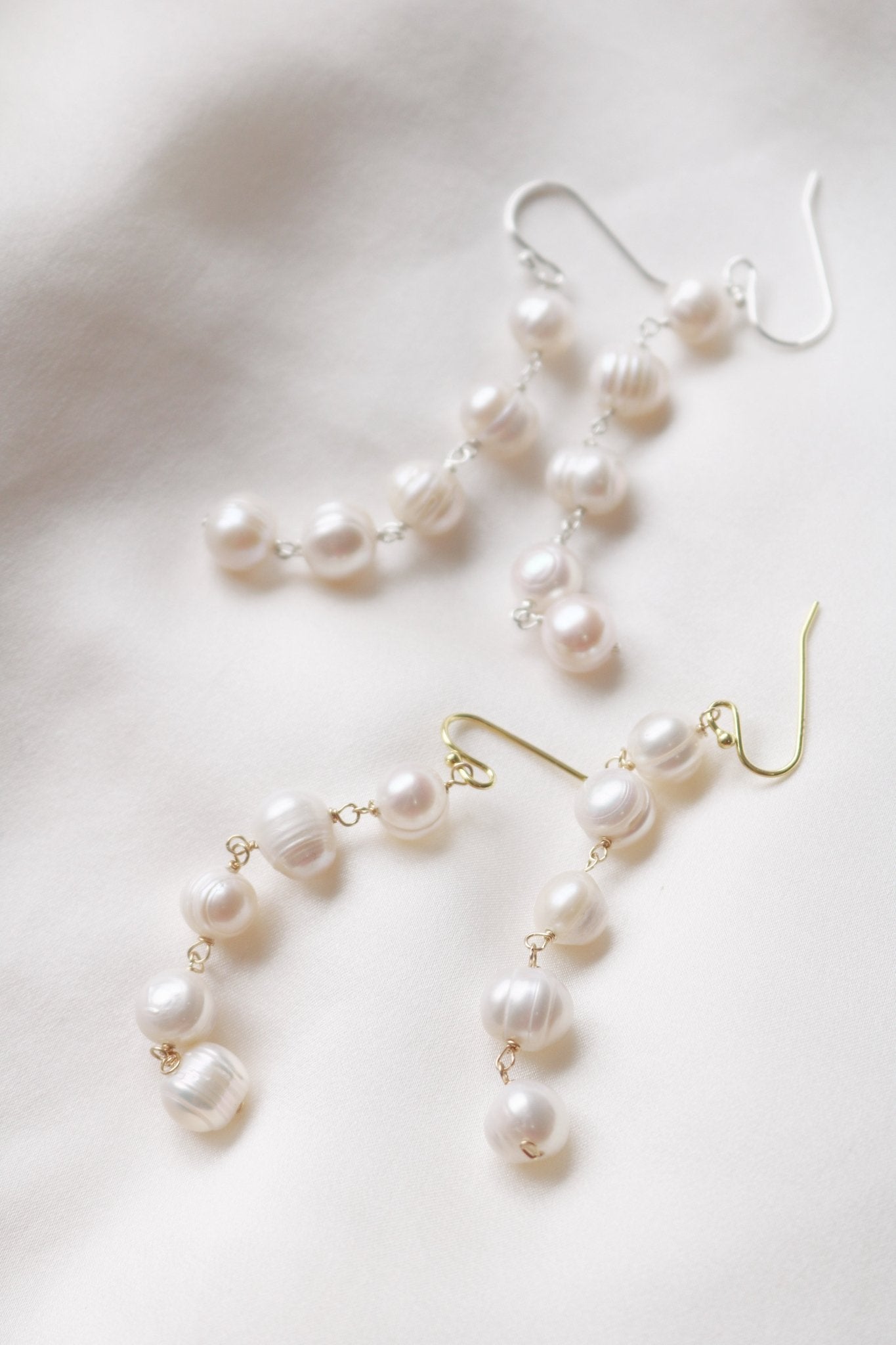 Two sets of Maisie Long Statement Fresh Water Pearl Bridal Earrings in gold and silver.