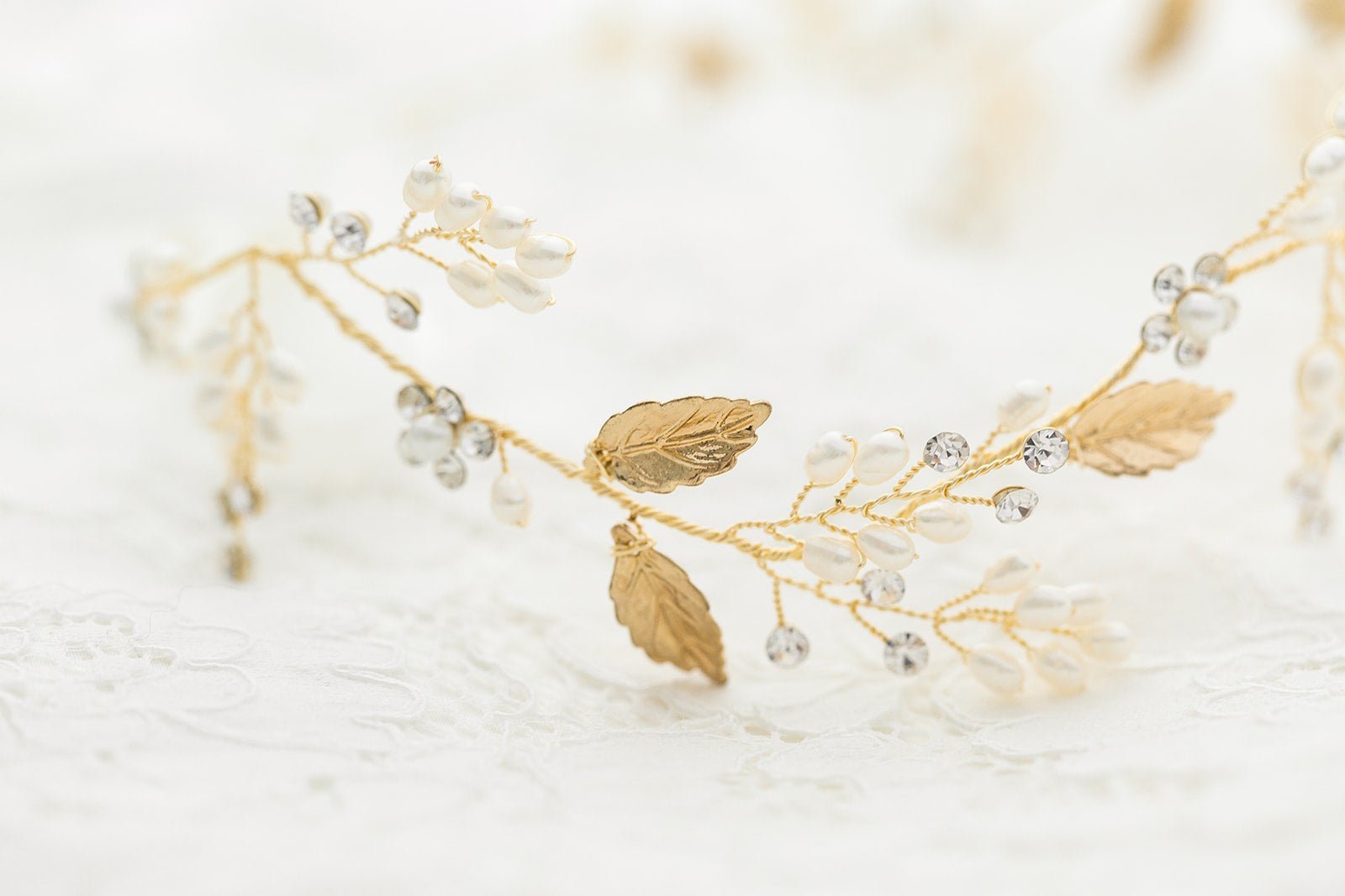 A close up of the Gold Meadow Freshwater Pearl and Crystal Leaf Bridal Hairvine on a white background. Bridal Hair Accessories. Bridal Accessories. Canadian Bridal Accessories. Handmade Canadian Accessories. Canadian handmade Accessories. Canadian weddings. Wedding Canada. Organic pearl accessories. Pearl Bridal Hair Accessories. Pearl Bridal Accessories.