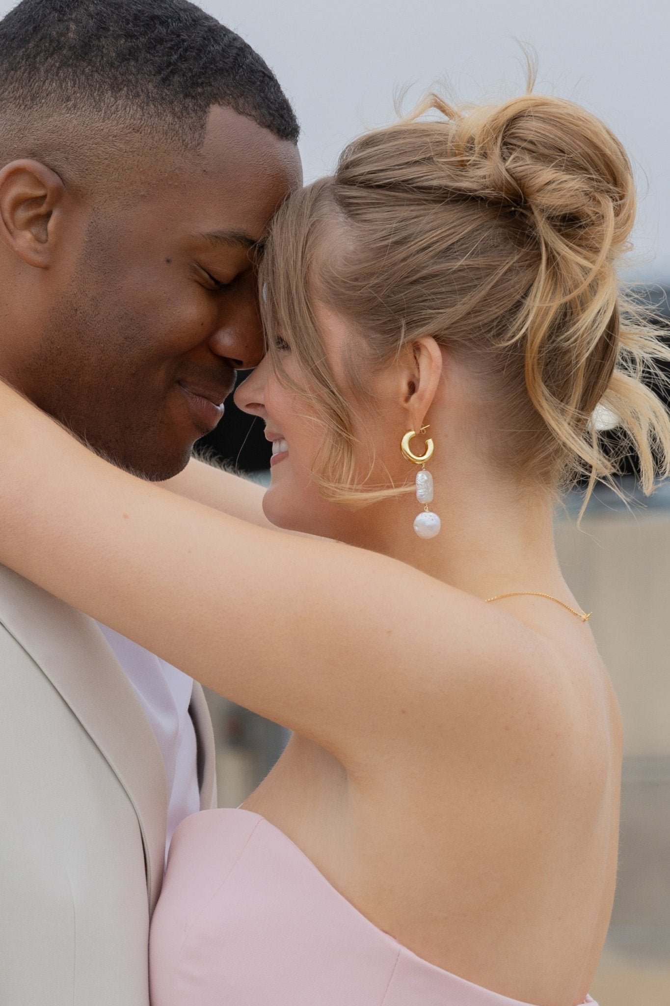 Bride and groom share intimate moment with bride wearing gold-filled Canadian bridal jewelry