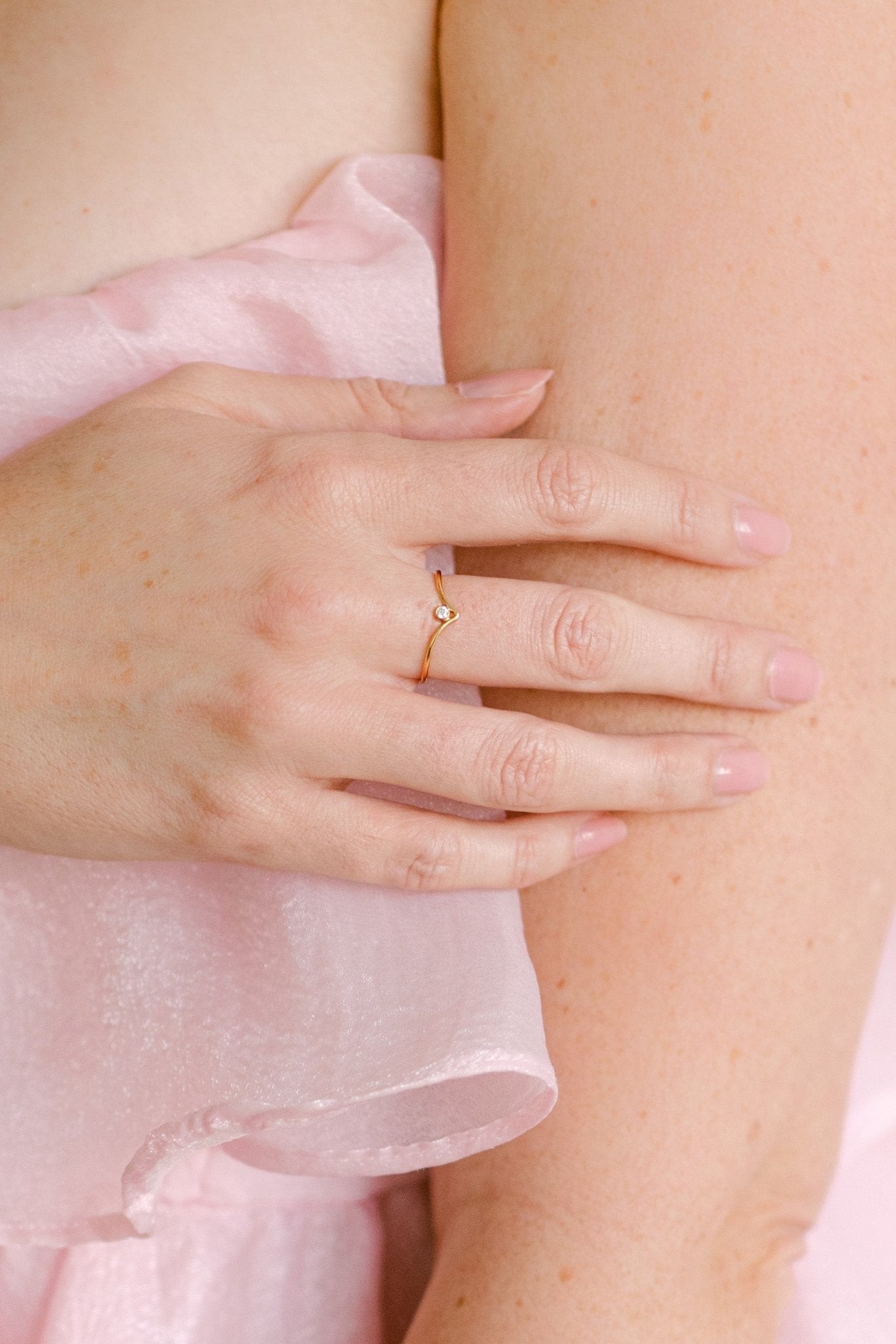 Close-up of a hand wearing a gold-filled peaked ring with cubic zirconia crystal. Woman-owned Canadian jewelry brand. Canadian handmade jewelry.