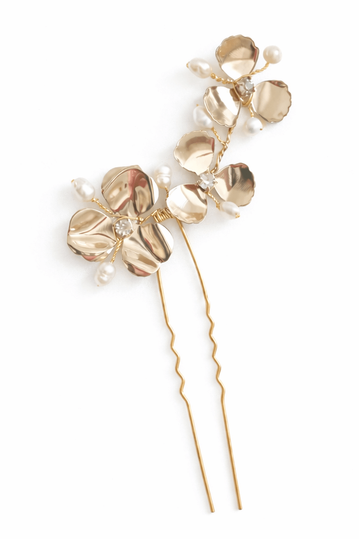 A gold flower bridal hairpin with freshwater pearls and crystals on a plain white background. Handmade bridal accessories and freshwater pearl accessories from Canadian jewelry brand.