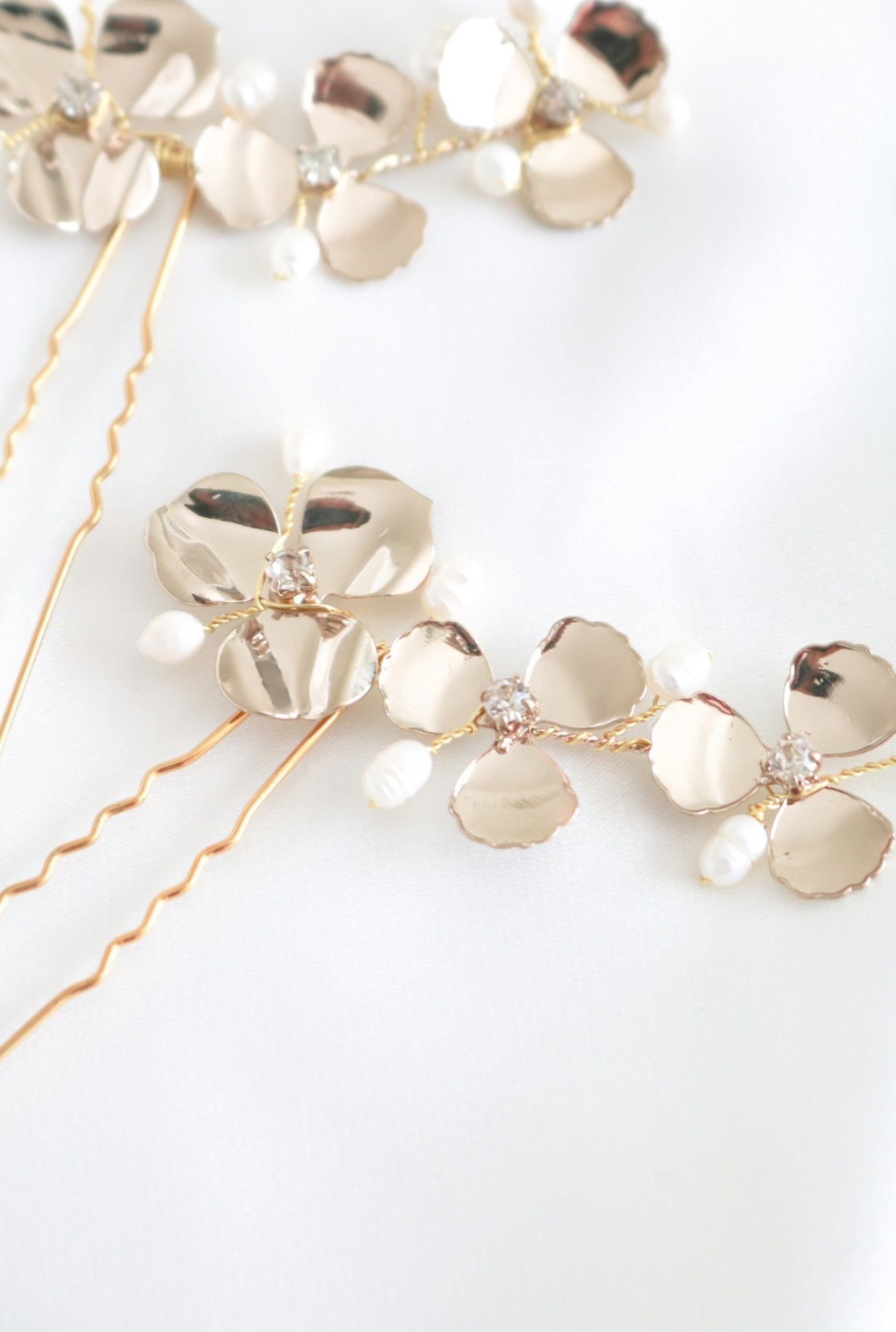 Two Posey Flower Hairpins with Fresh Water Pearls for wedding on white backdrop. 