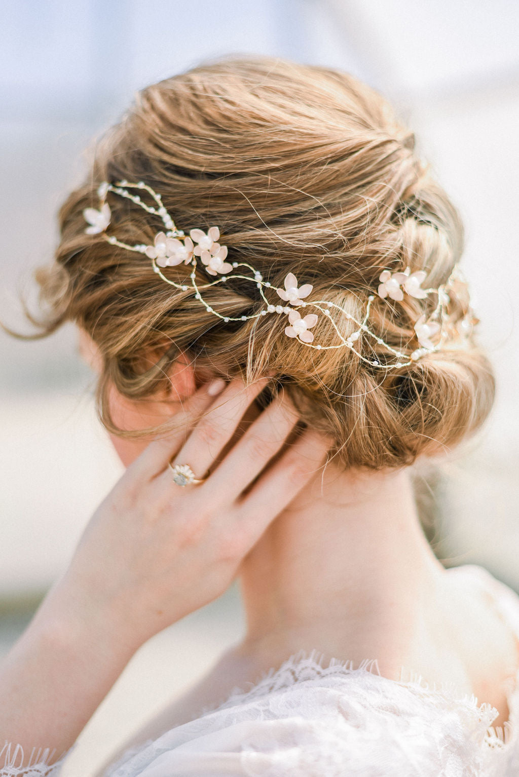 Bride with floral bridal hair accessory in a styled updo. Bridal jewelry Canada. Canadian weddings. Canadian jewelry business. Bridal Hair Accessories. Pearl Bridal Accessories. Canadian bridal jewelry