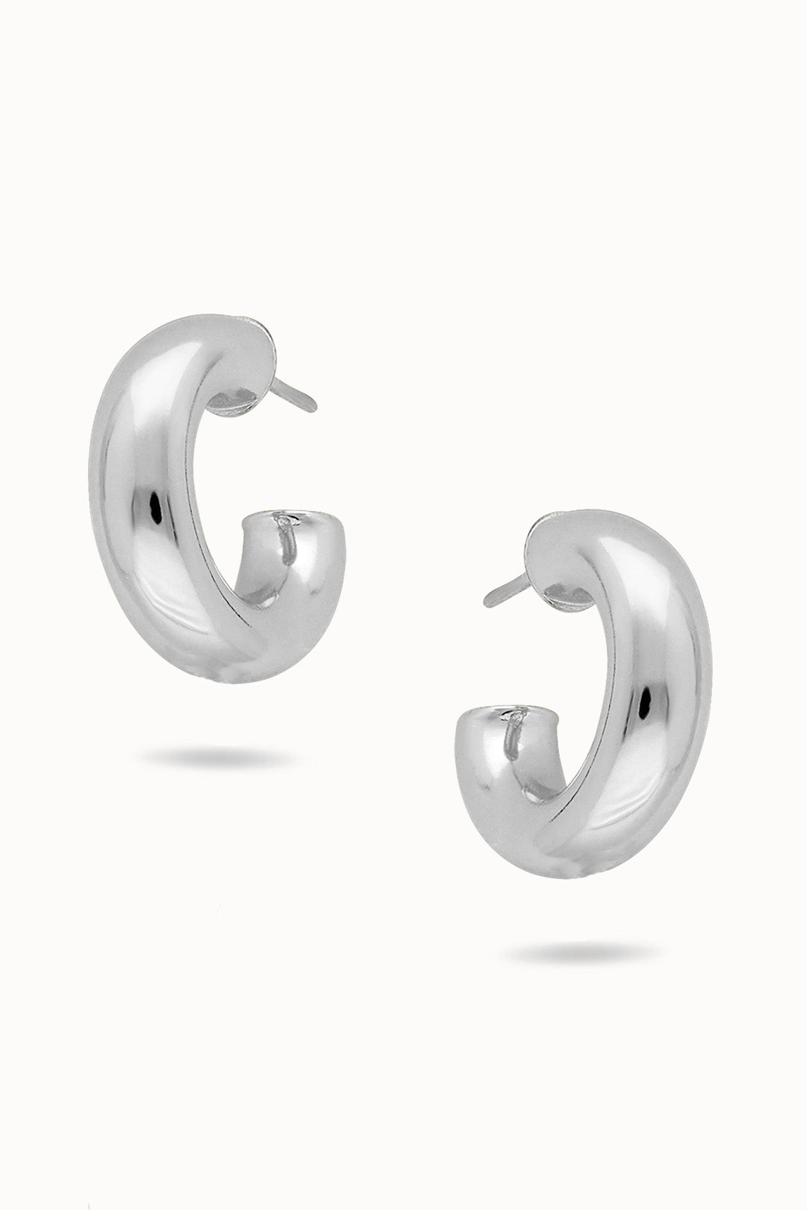 Pair of puffy sterling silver hoop earrings on a white background. Canadian handmade jewelry. Small Canadian jewelry brands.