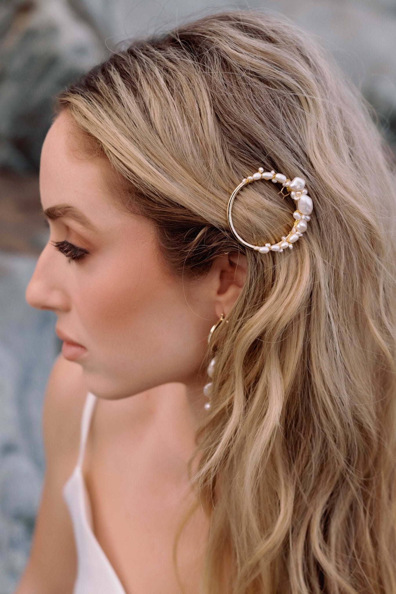 Beautiful bride showcases a gold-filled circle pearl barrette.