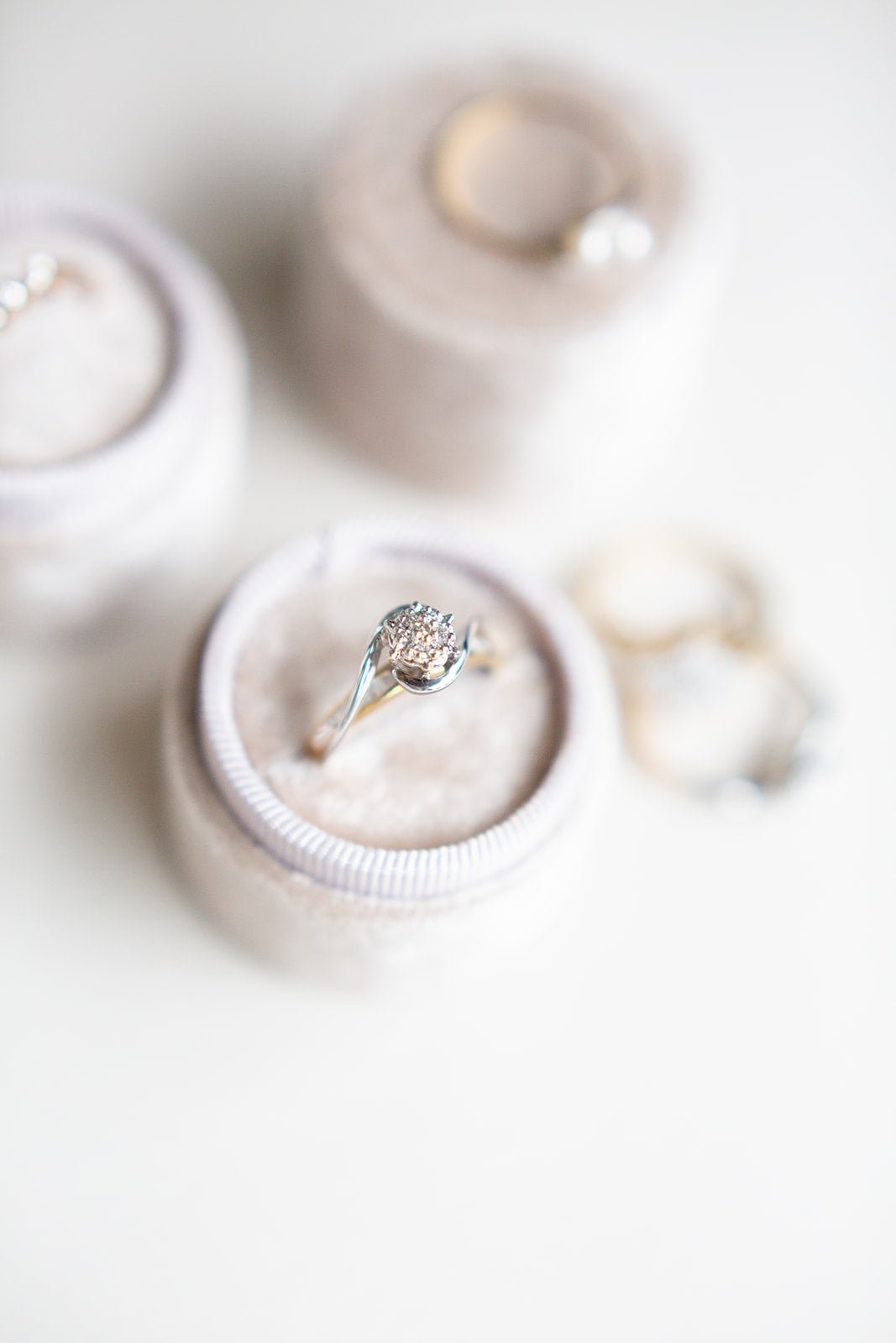 Top view of a 10k gold and diamond vintage engagement ring sitting in a round ring box. 