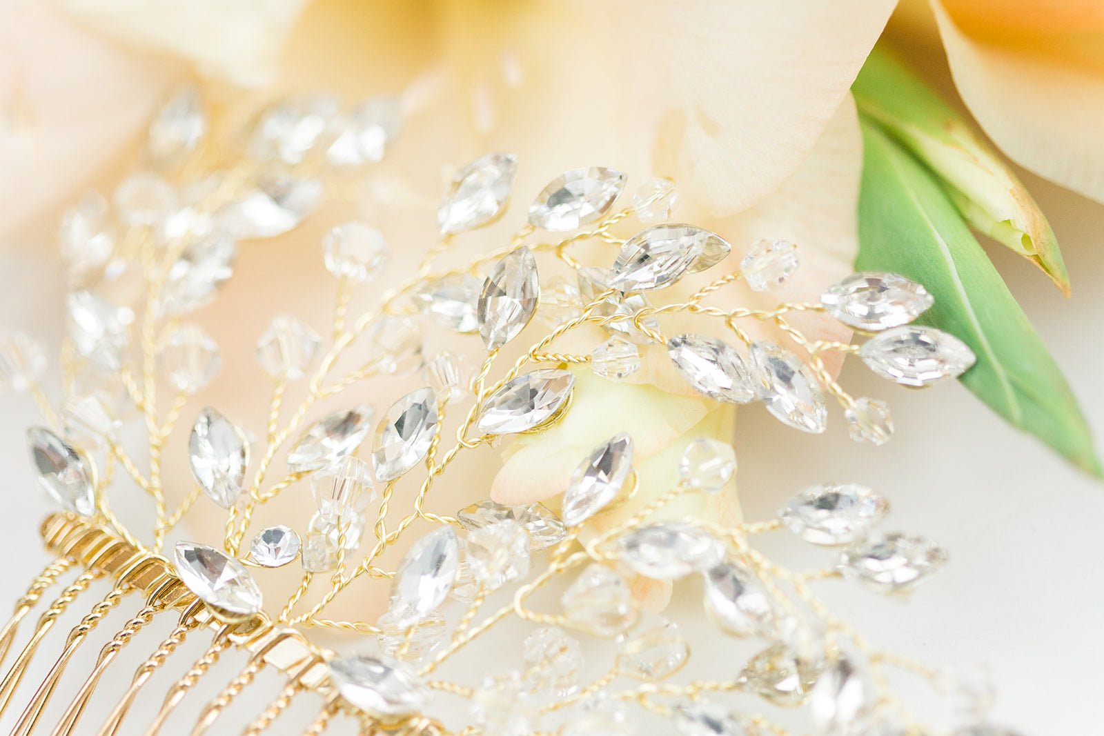 An extreme close of a gold wire-wrapped crystal leaf bridal hair comb. Bridal Hair Accessories, Canadian Bridal Accessories, & Handmade Canadian Accessories by BIPOC bridal designer