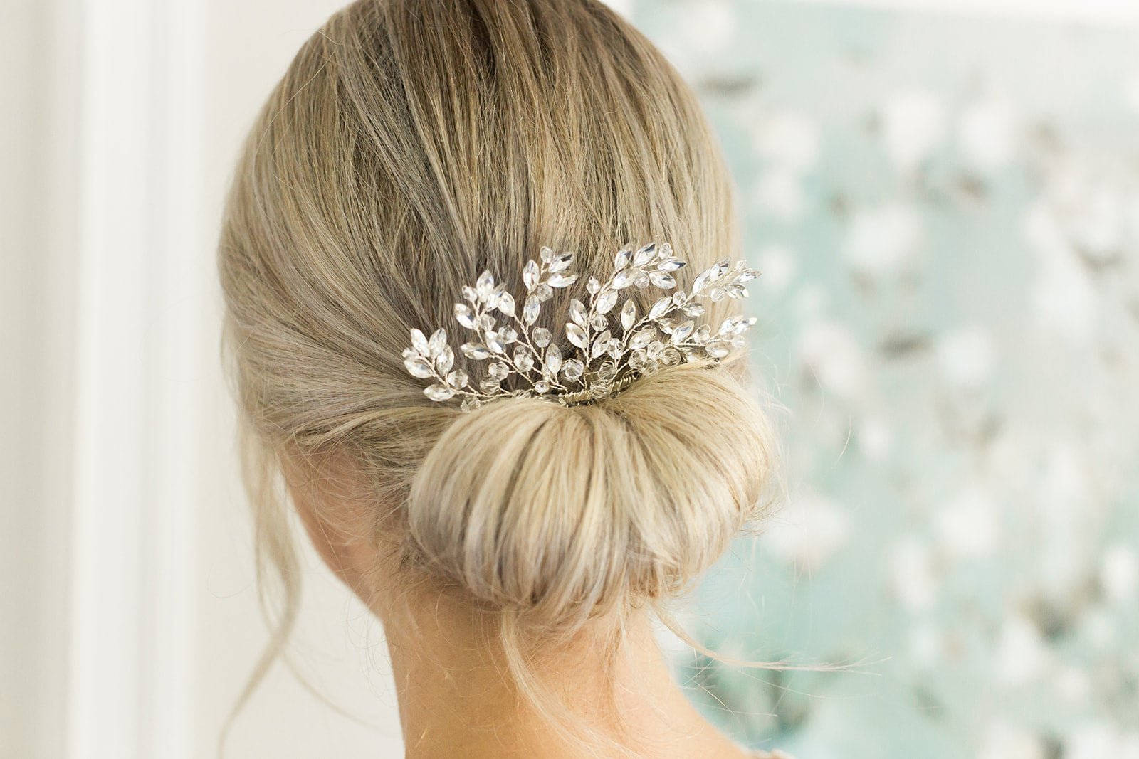 A gold Willow Crystal bridal hair comb is tucked into a tight blonde bridal bun. Bridal Hair Accessories. Bridal Accessories. Canadian Bridal Accessories. Handmade Canadian Accessories. Canadian handmade Accessories. Canadian weddings. Wedding Canada.