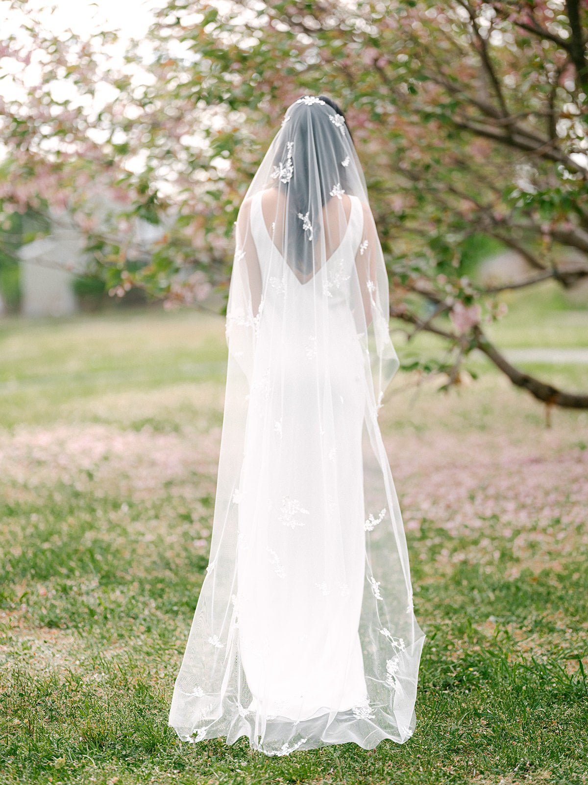 A bride's Wisteria Lace Leaf Wedding Veil cascades down her back; just touching the ground. Canadian weddings. Wedding Canada. Wedding veils Canada. Bridal Hair Accessories. Bridal Accessories. Canadian Bridal Accessories. Handmade Canadian Accessories. Canadian handmade Accessories. Canadian designer. Canadian artist.