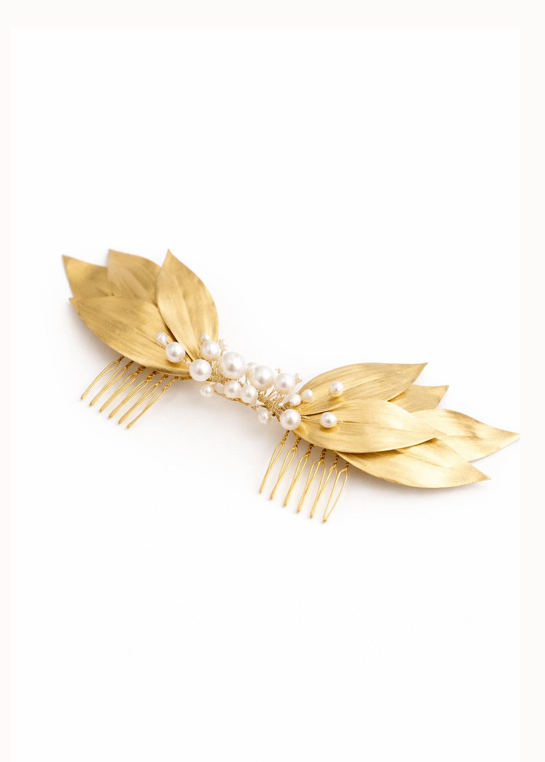 The Gold Loria Leaf and Freshwater Pearl Bridal Hair Comb on a white background next to dusty roses. Bridal Hair Accessories. Bridal Accessories. Canadian Bridal Accessories. Handmade Canadian Accessories. Canadian handmade Accessories. Canadian weddings. Wedding Canada. 