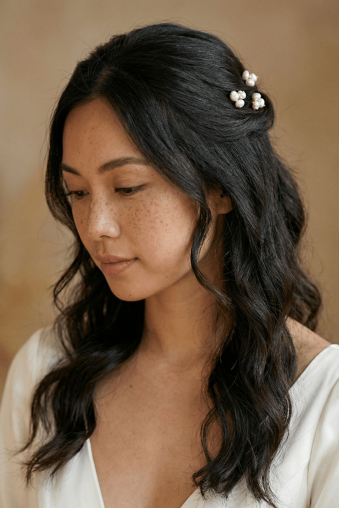 pearl hairpins in a filipina brides hair, with a neutral background. handmade bridal accessories in canada with philipino pearls