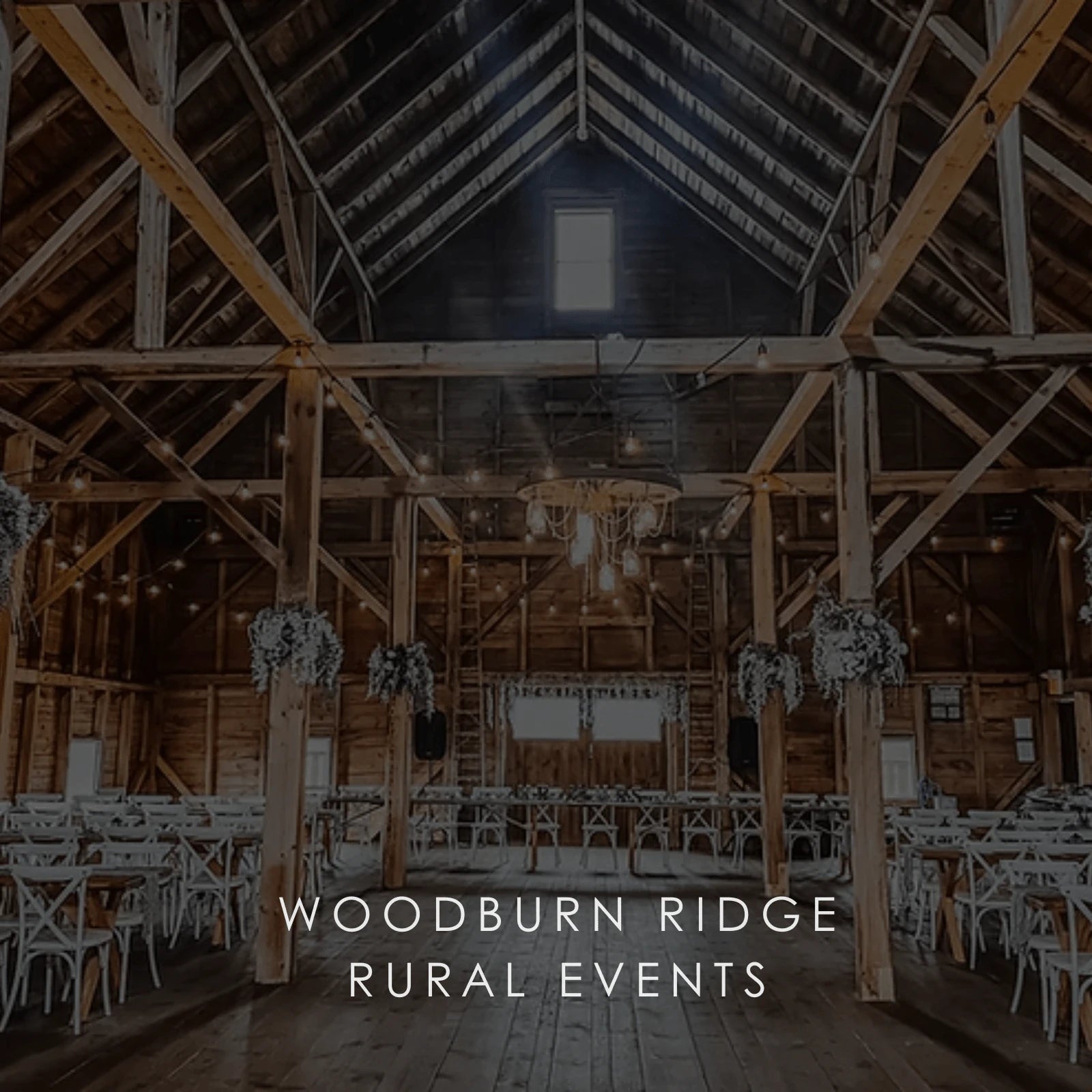 A wide space inside a wooden building set up for a wedding in a photo for Woodburn Ridge Rural Events.